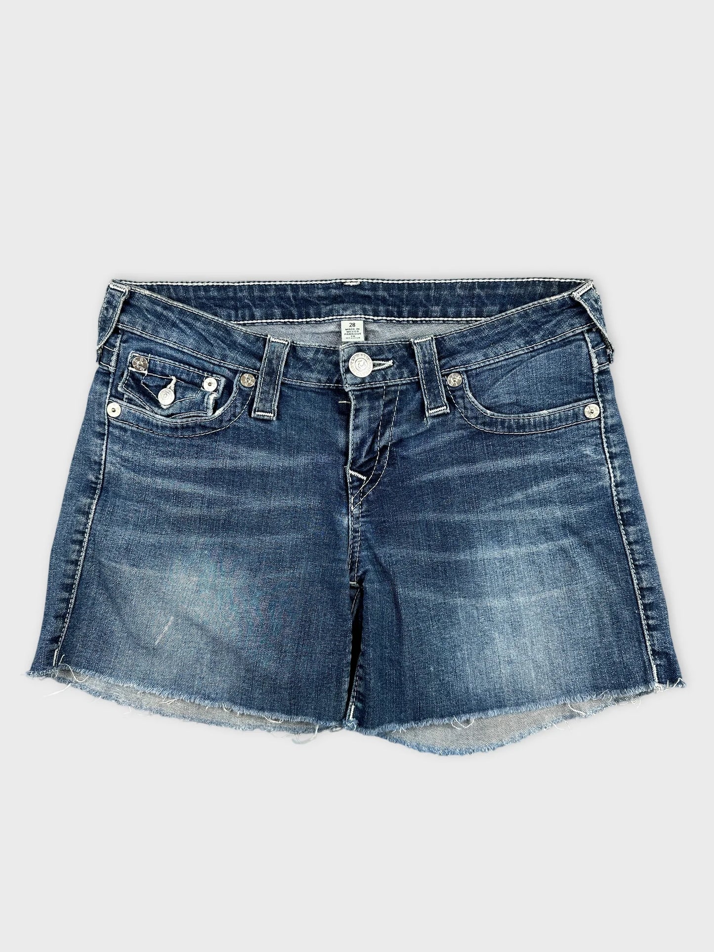Front view of women denim shorts in dark blue with frayed hem.