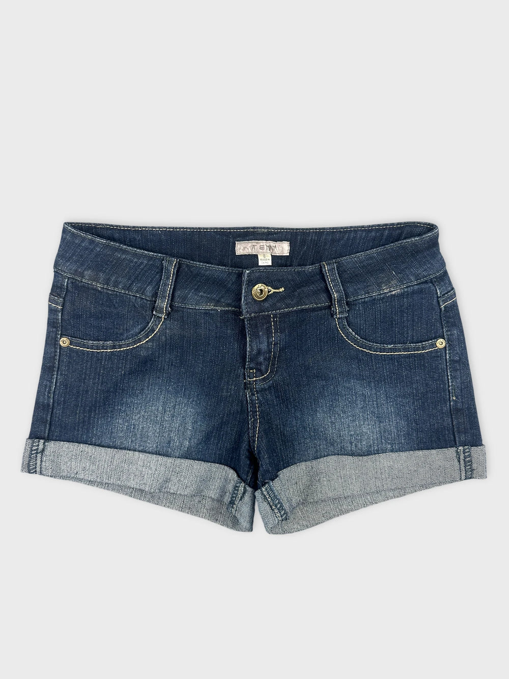 Front view of women denim shorts in dark blue with rolled hem.