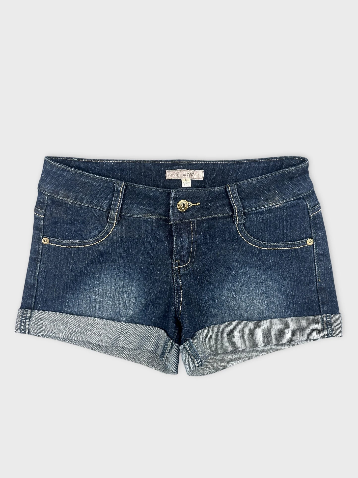 Front view of women denim shorts in dark blue with rolled hem.