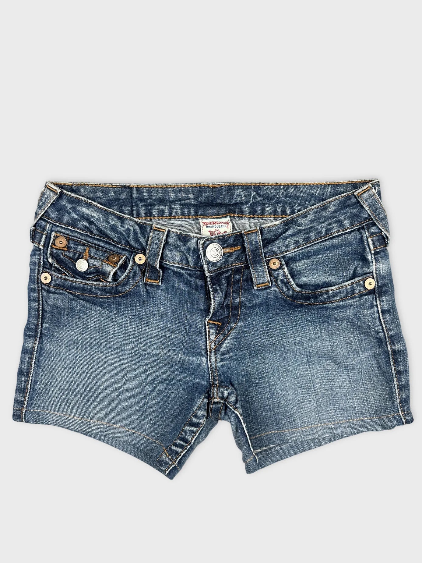 Front view of women denim shorts in faded blue with button details.