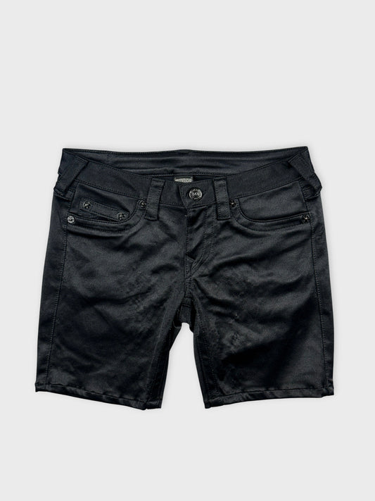 Front view of black denim shorts featuring front pockets and button detail.