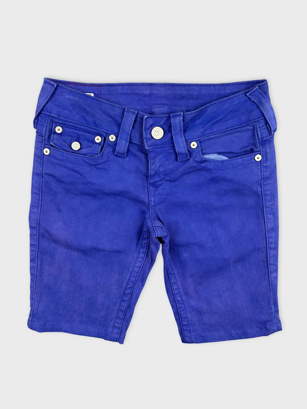 Front view of blue denim shorts featuring button details and pockets.