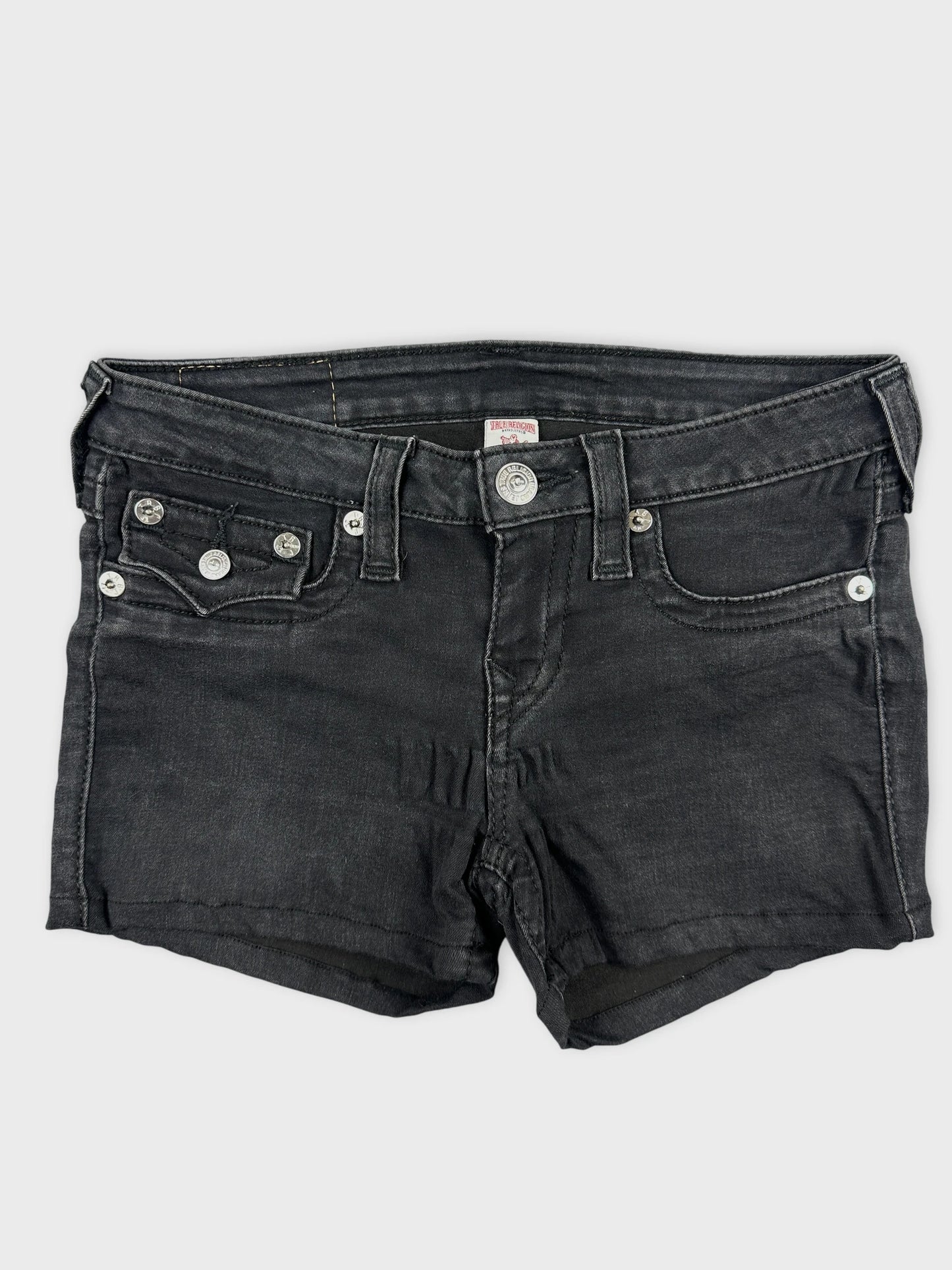 Front view of black denim shorts with silver button details and pockets.