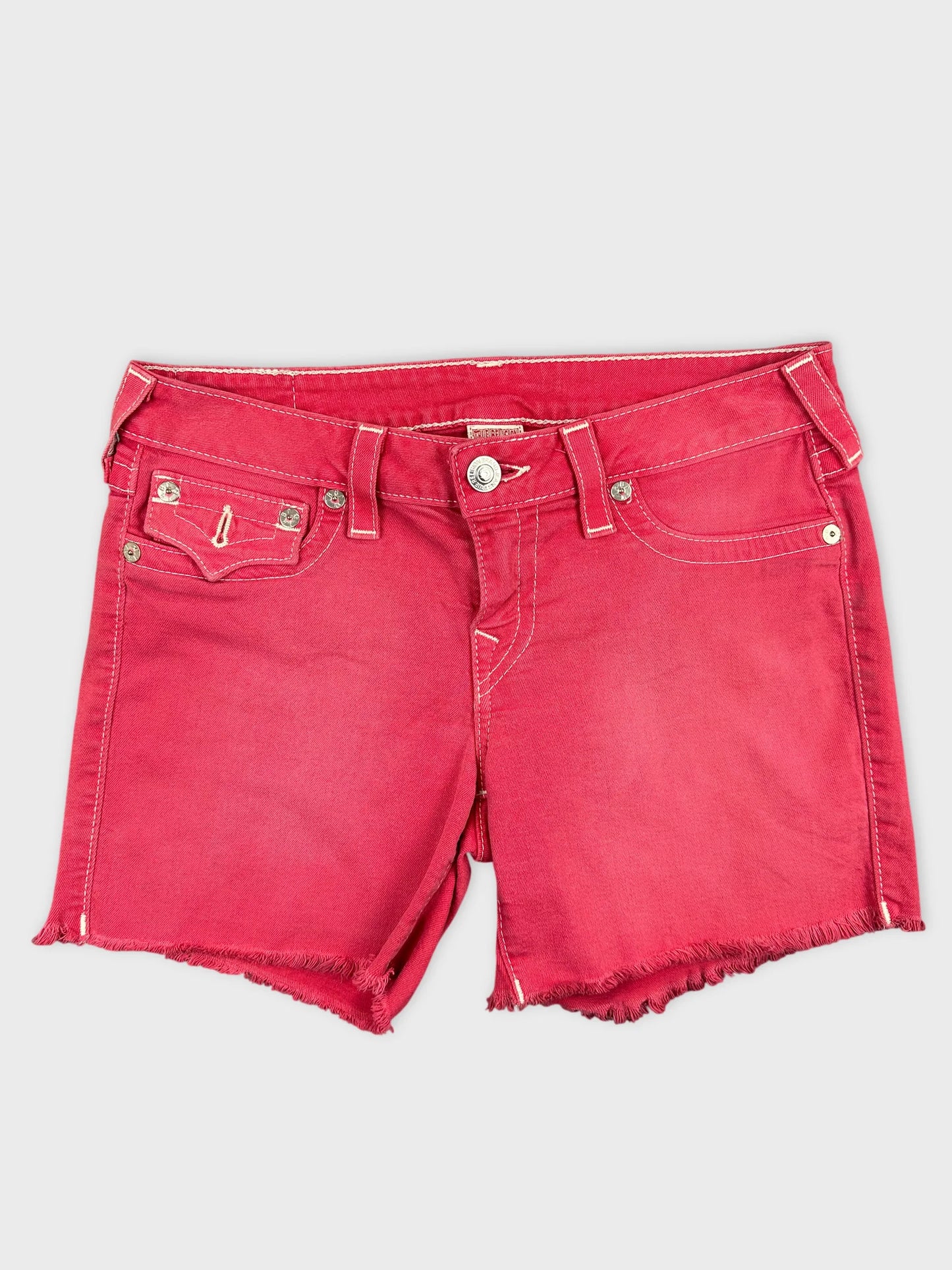 Front view of red denim shorts featuring frayed hem and pockets.