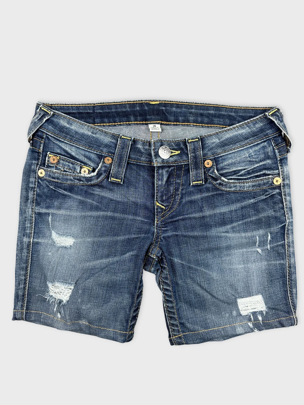Front view of women denim shorts with distressed detailing and yellow stitching.