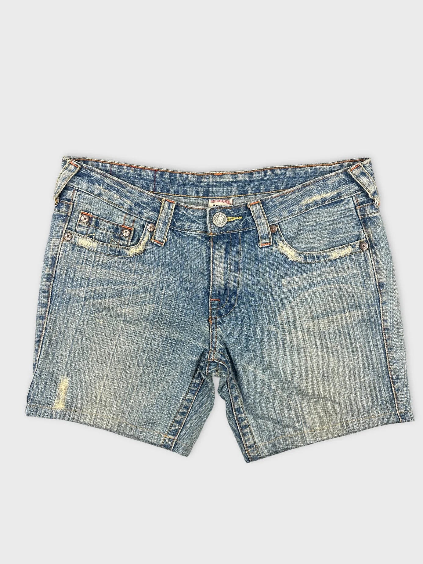 Front view of women denim shorts in faded blue with distressed detailing.