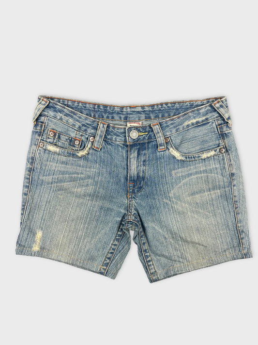 Front view of women denim shorts in faded blue with distressed detailing.