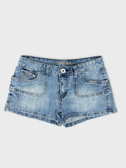 Front view of blue denim shorts with front pockets and frayed hem.