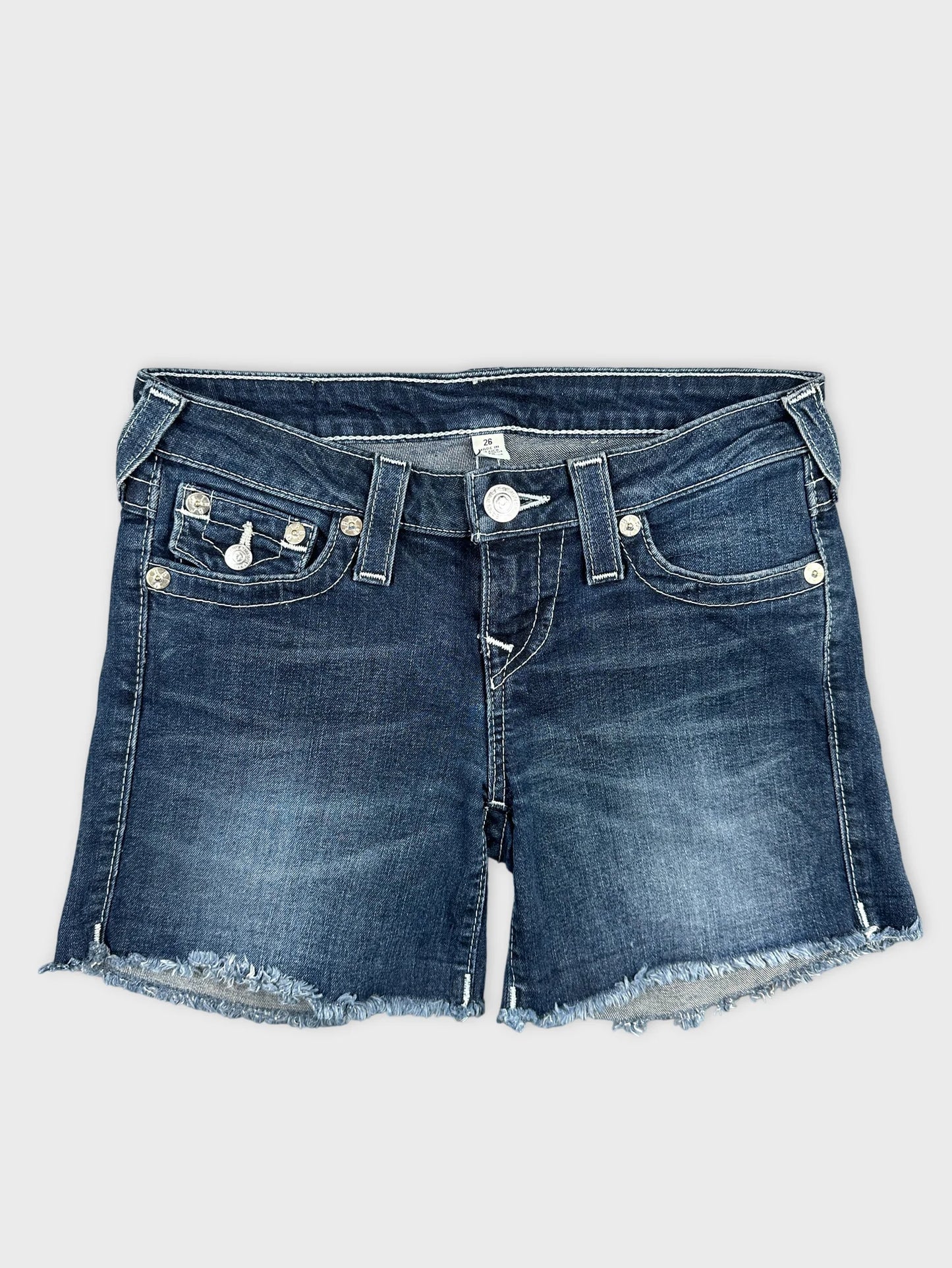 Front view of women denim shorts in dark blue with frayed hem.