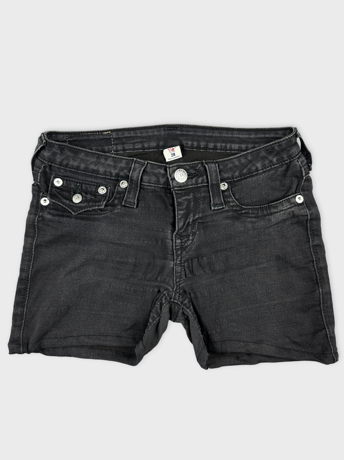 Front view of black denim shorts with silver button details.