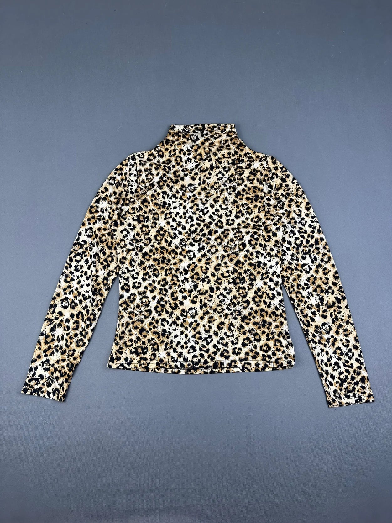 Back view of a long sleeve leopard print shirt in beige and black.