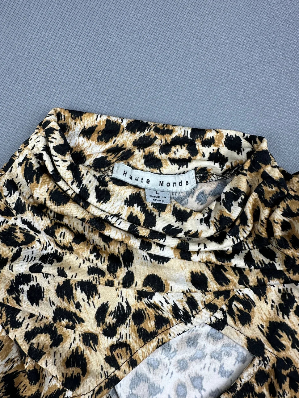 Detail view of a women's long sleeve shirt in leopard print.
