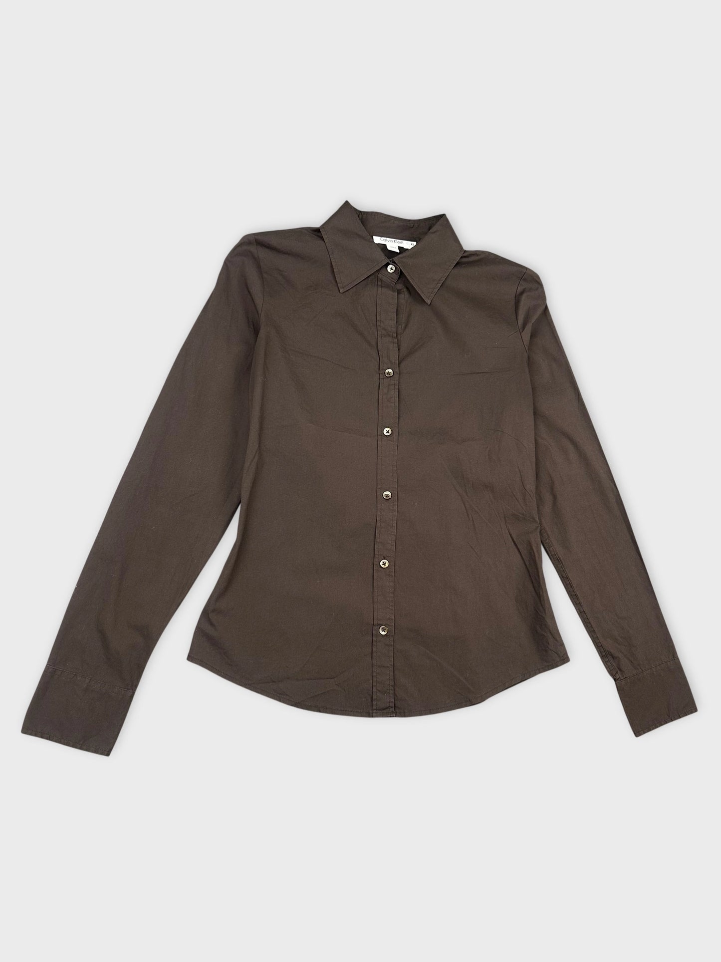 Detail view of a long sleeve shirt in dark brown with buttons