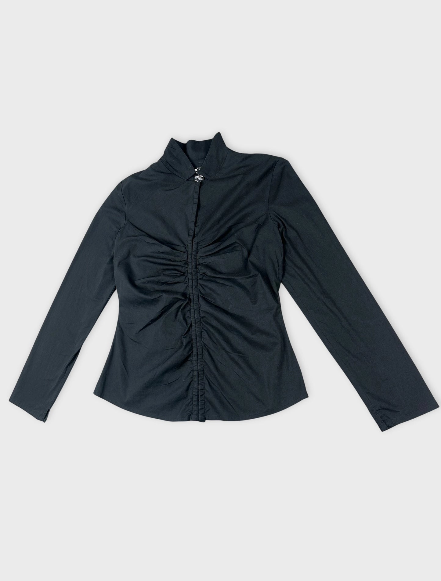 Detail view of black long sleeve shirt featuring gathered fabric at the front.