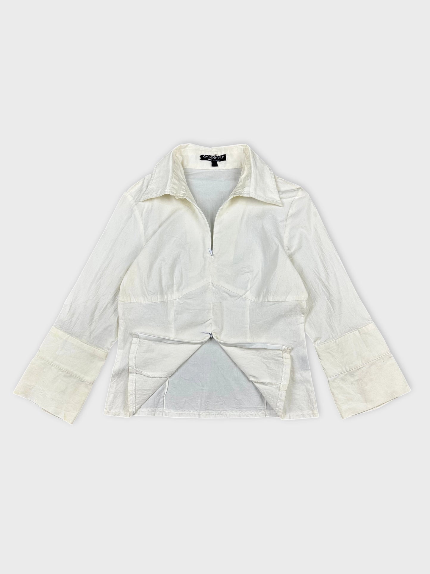 Women long sleeve shirt in light cream with a zip detail view.