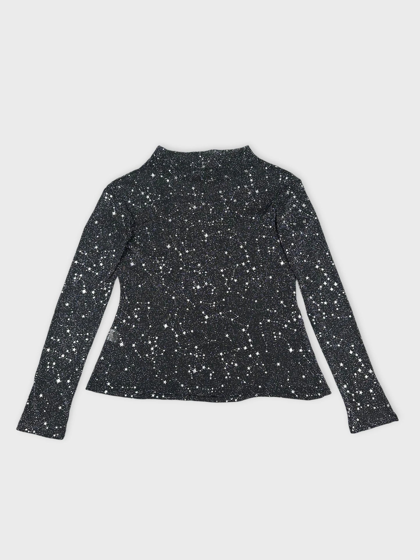 Detail view of a black long sleeve shirt with starry print.