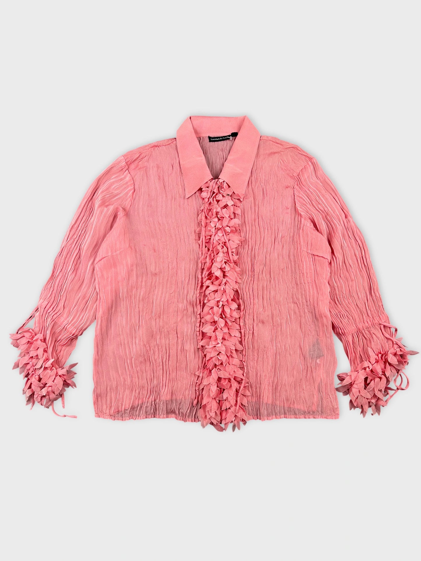 Front view of a pink long sleeve shirt with ruffled trim.