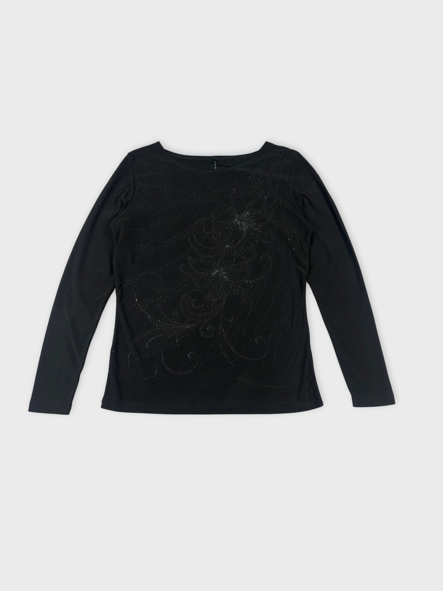 Front view of a black long sleeve shirt with decorative swirl pattern.