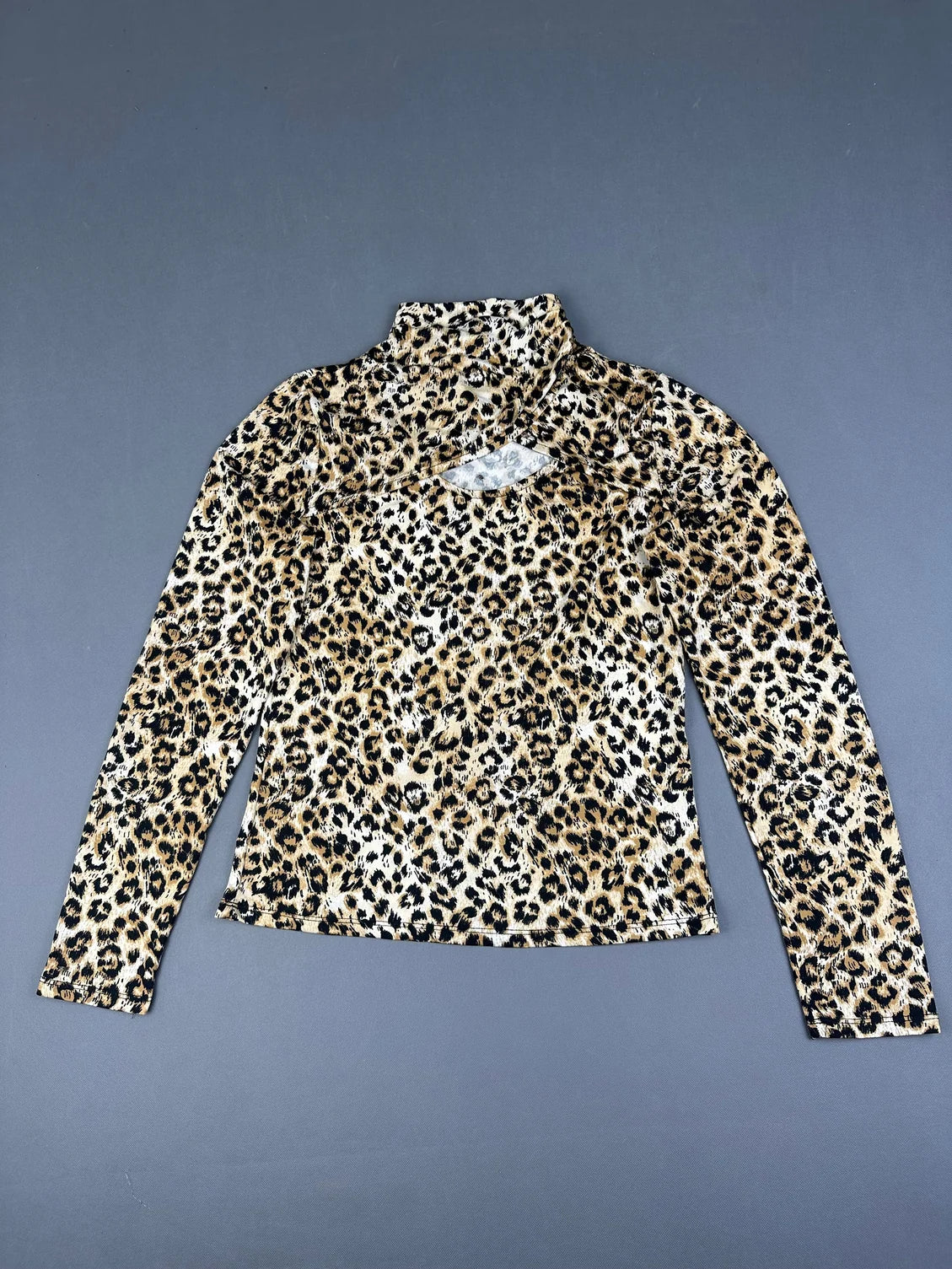 Long sleeve shirt in leopard print with a mock neck front view.