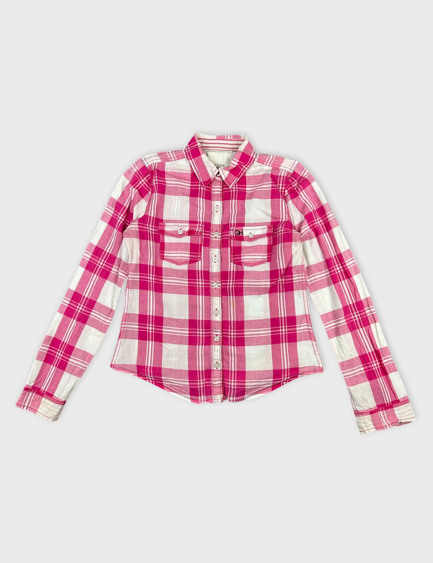 Front view of a pink plaid long sleeve shirt with two chest pockets.