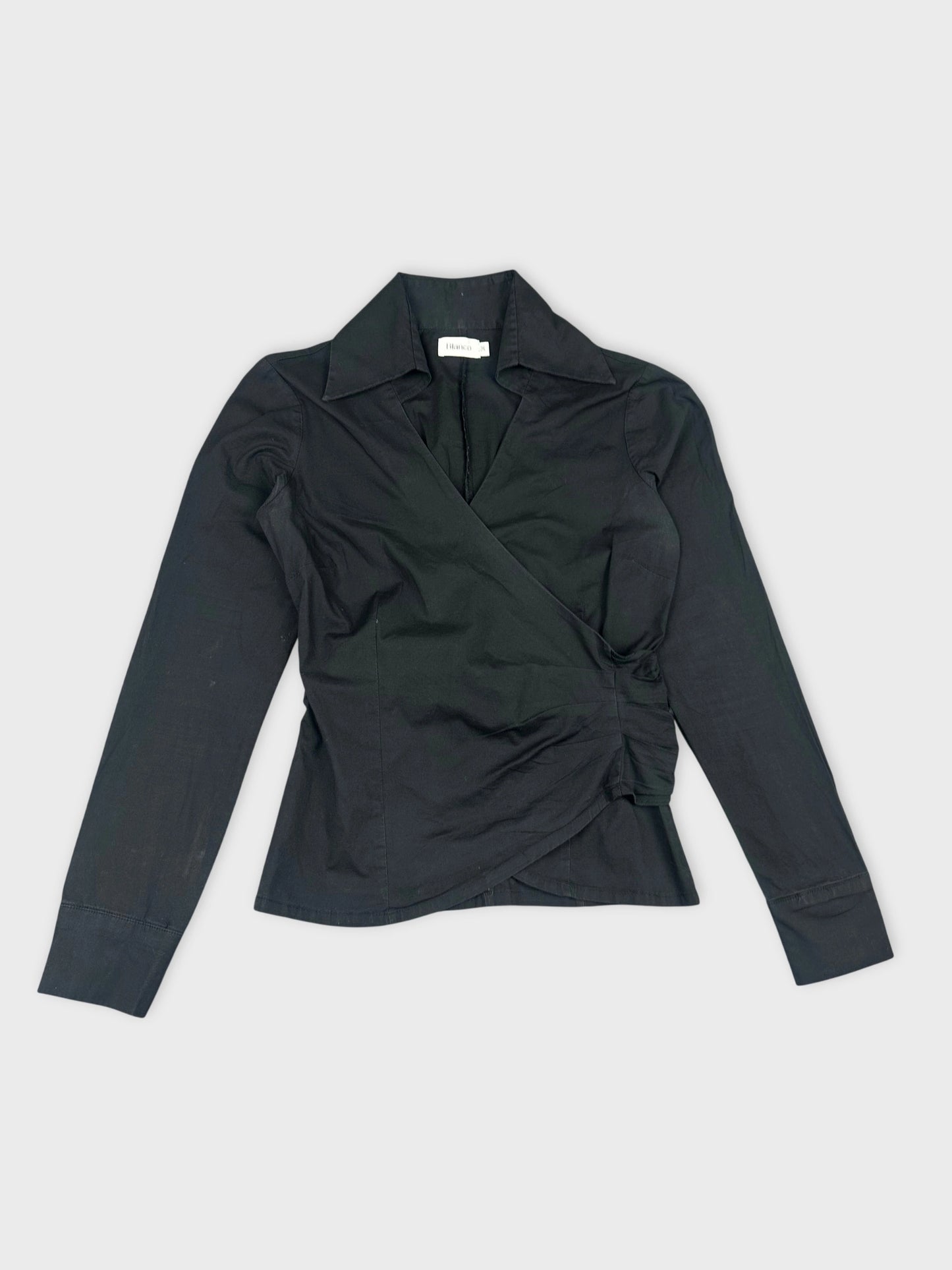 Front view of a black long sleeve shirt with a wrap design.