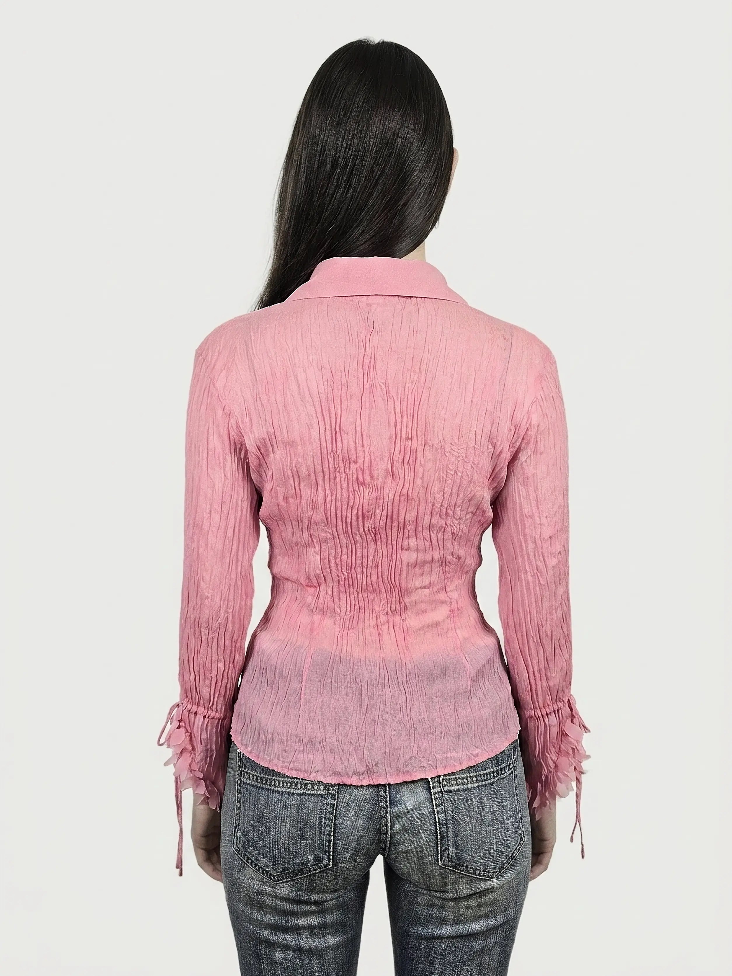 Back view of a pink long sleeve shirt with textured fabric and shirred details.