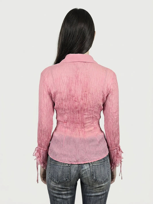 Back view of a pink long sleeve shirt with textured fabric and shirred details.