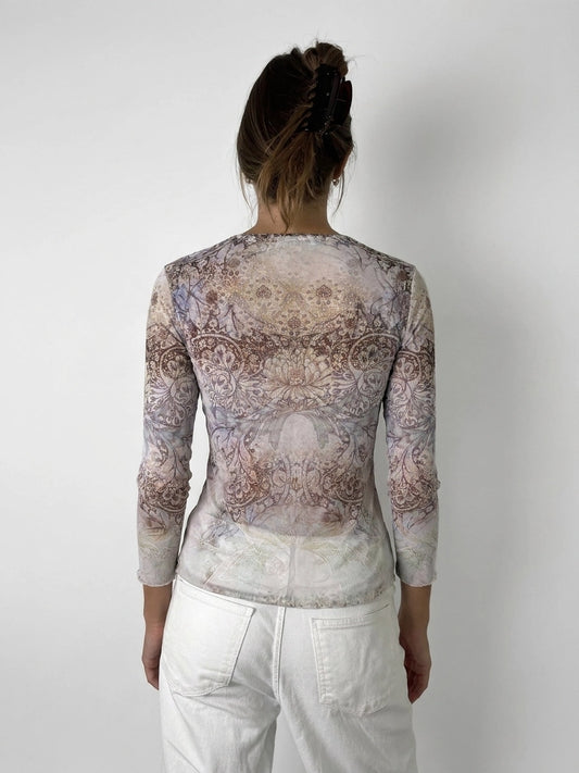 Back view of a long sleeve shirt in pastel colors with intricate floral print.