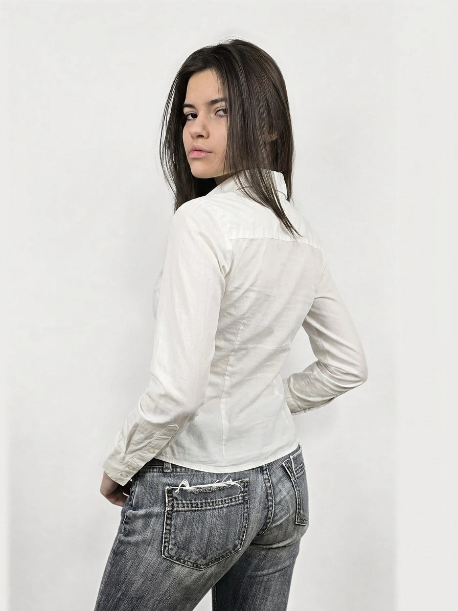 Back view of a white long sleeve shirt with a collared neckline.