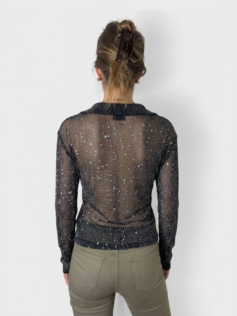 Back view of a black long sleeve shirt with star print.