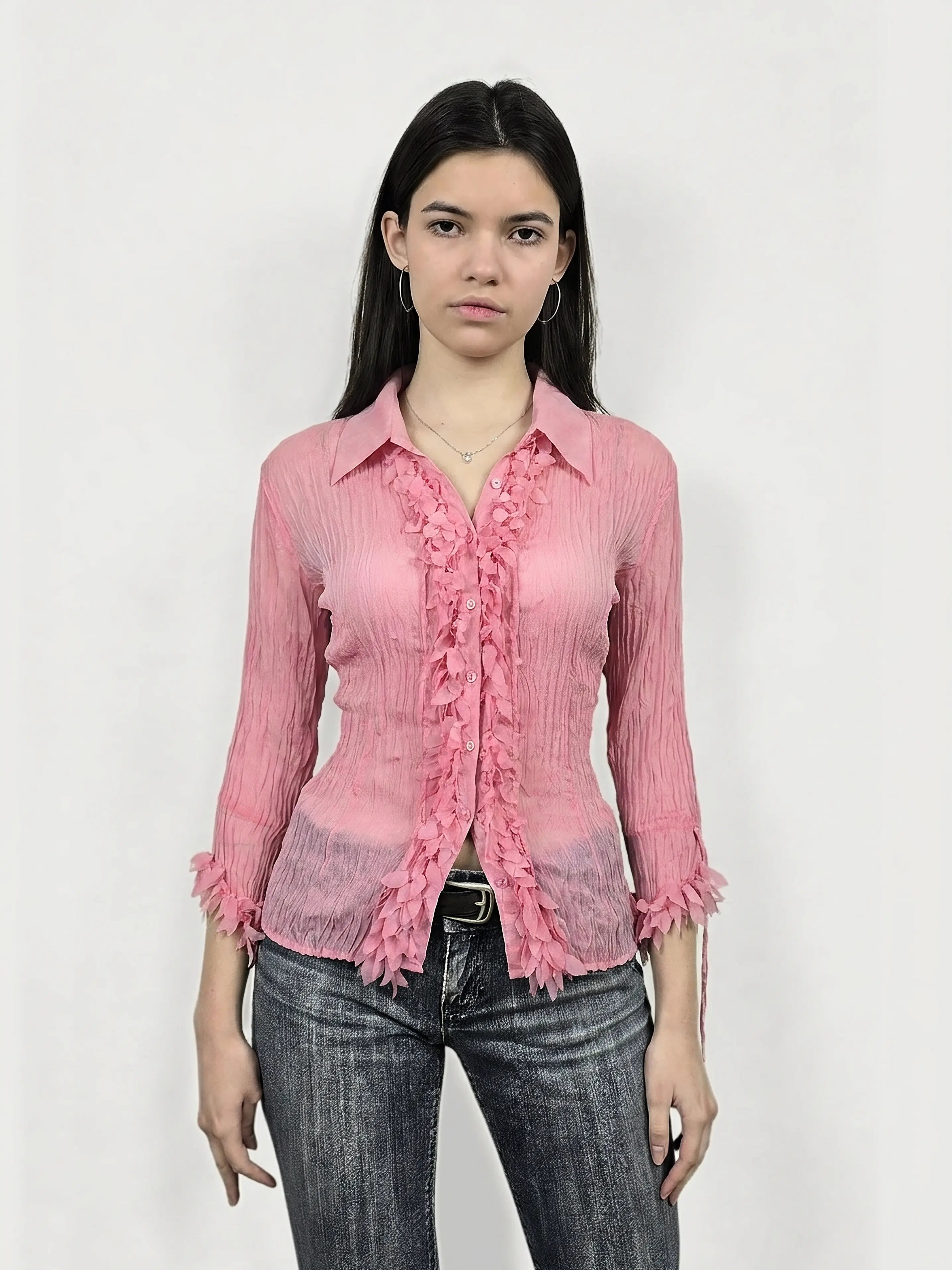 Front view of a pink long sleeve shirt featuring ruffled trim.