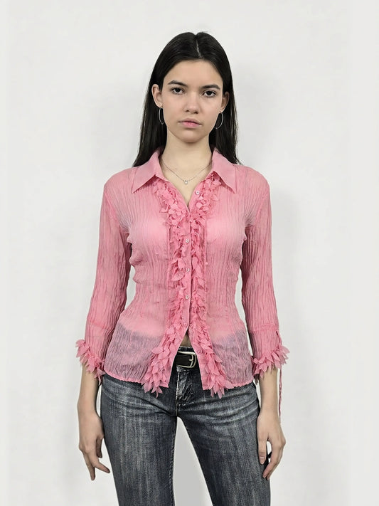 Front view of a pink long sleeve shirt featuring ruffled trim.