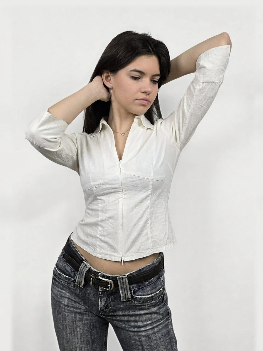 Front view of a white long sleeve shirt featuring a zipper detail.