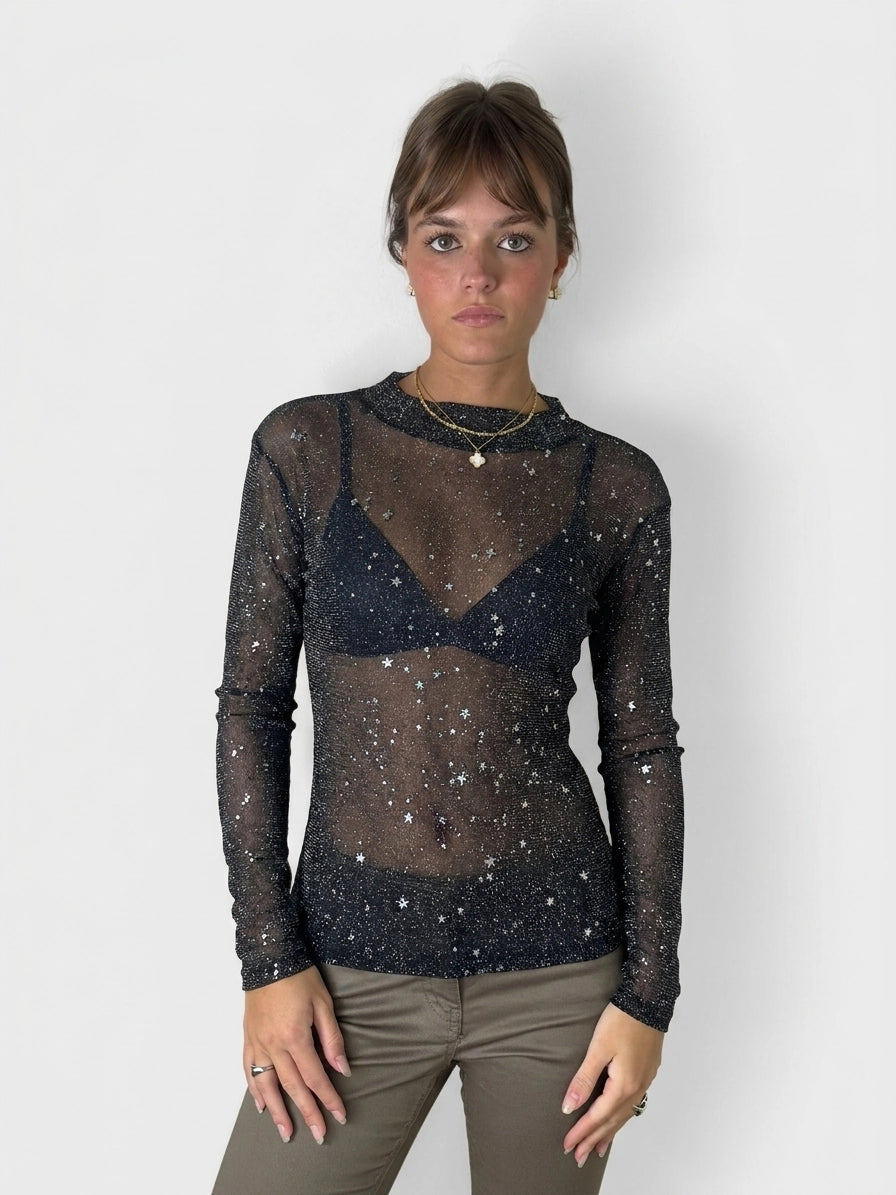 Black long sleeve shirt with star print, front view.