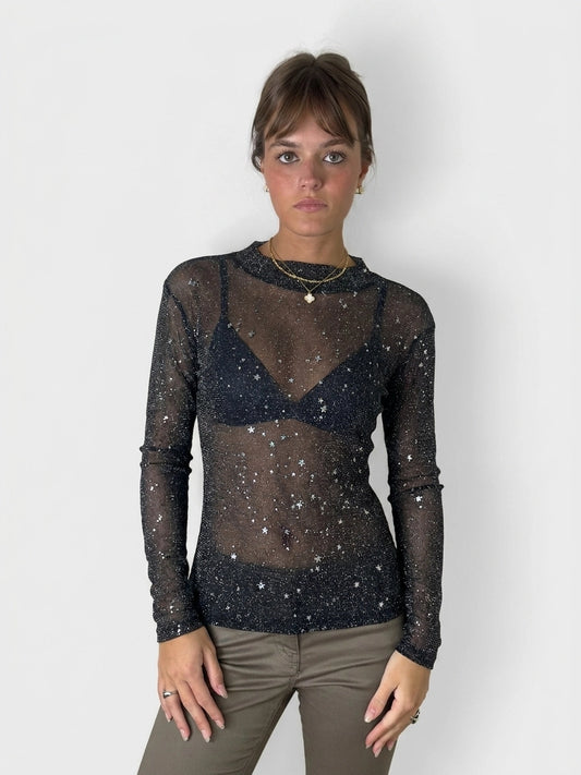 Black long sleeve shirt with star print, front view.
