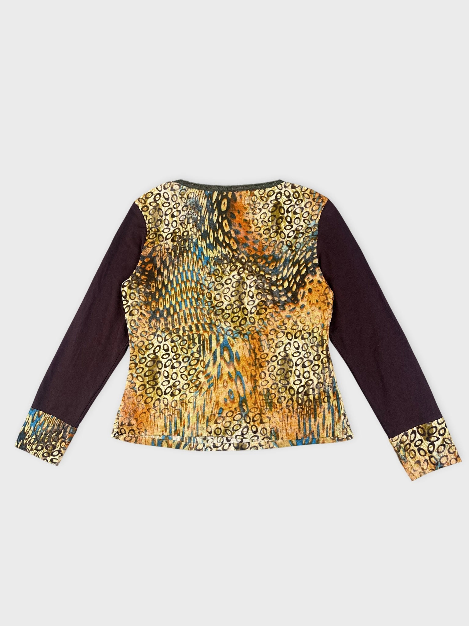 Back view of a long sleeve top in earthy tones with a vibrant print.