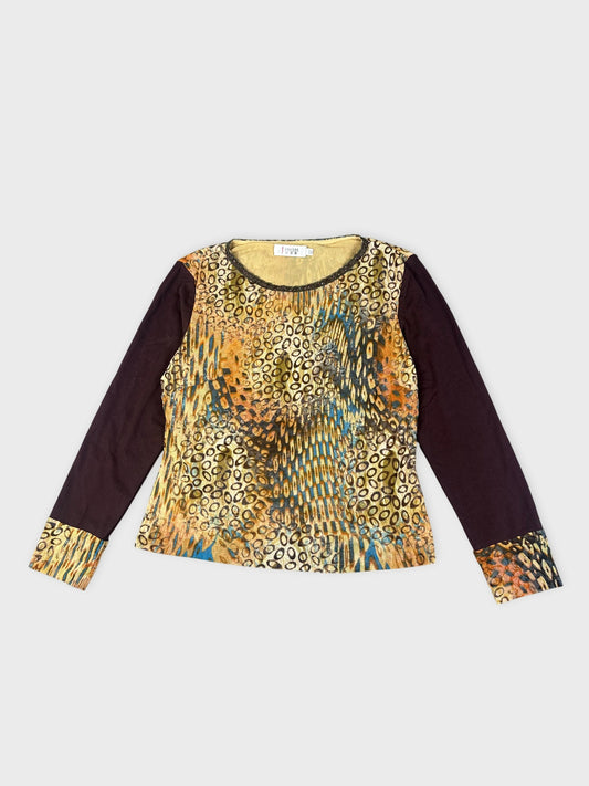 Front view of a long sleeve top in gold and brown with a patterned design.
