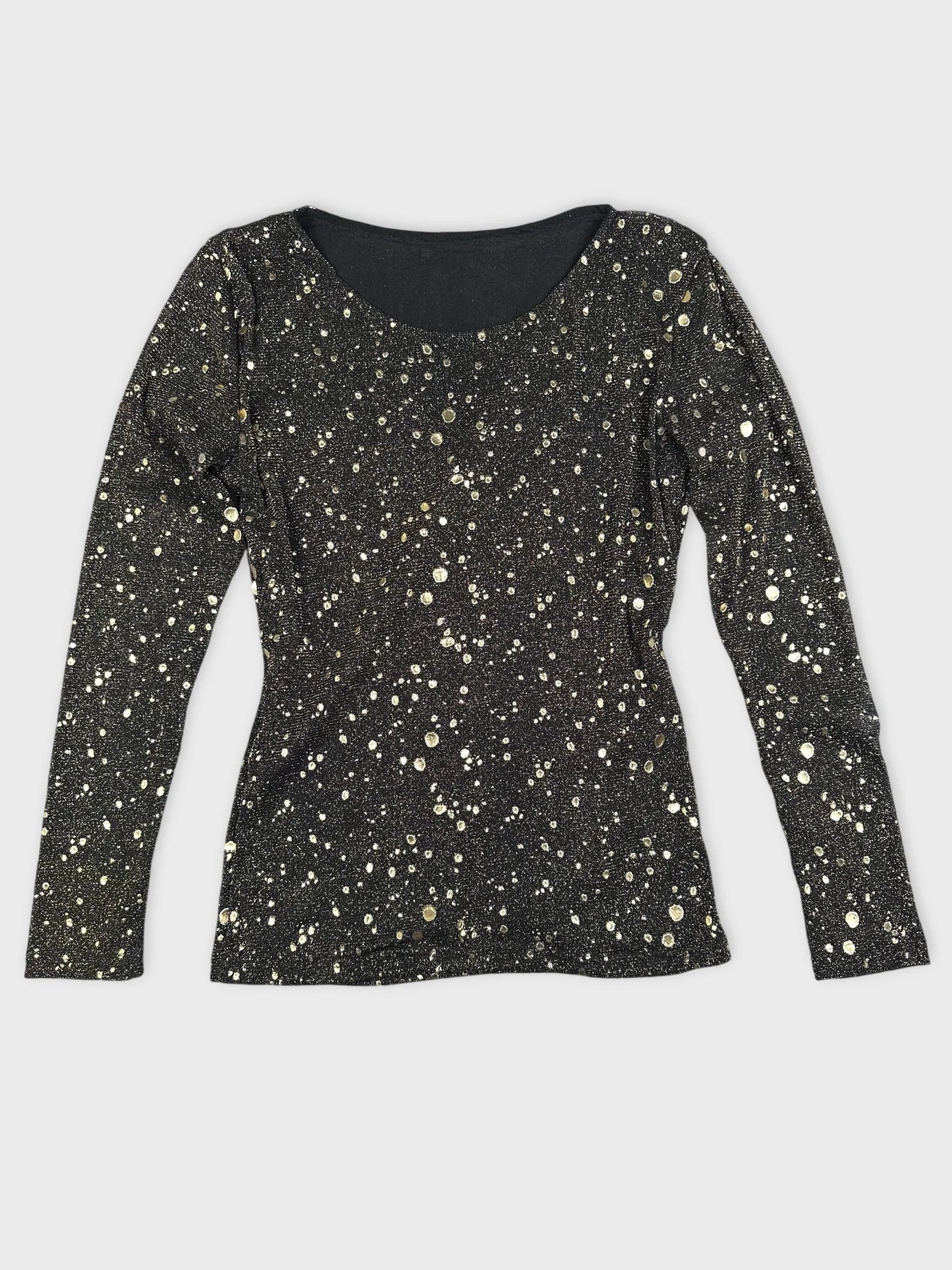 Front view of a long sleeve black top with gold dot pattern.