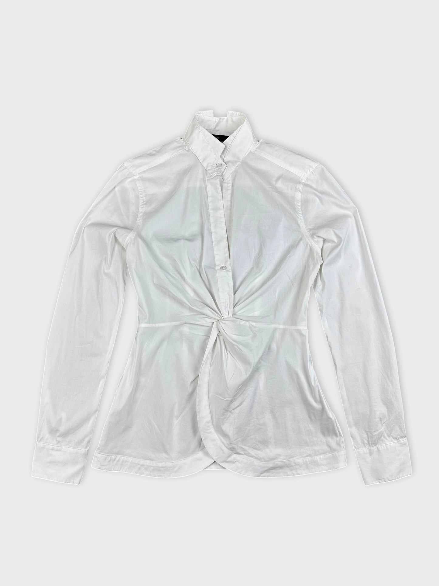 Detail view of a white long sleeve top with a knotted front.