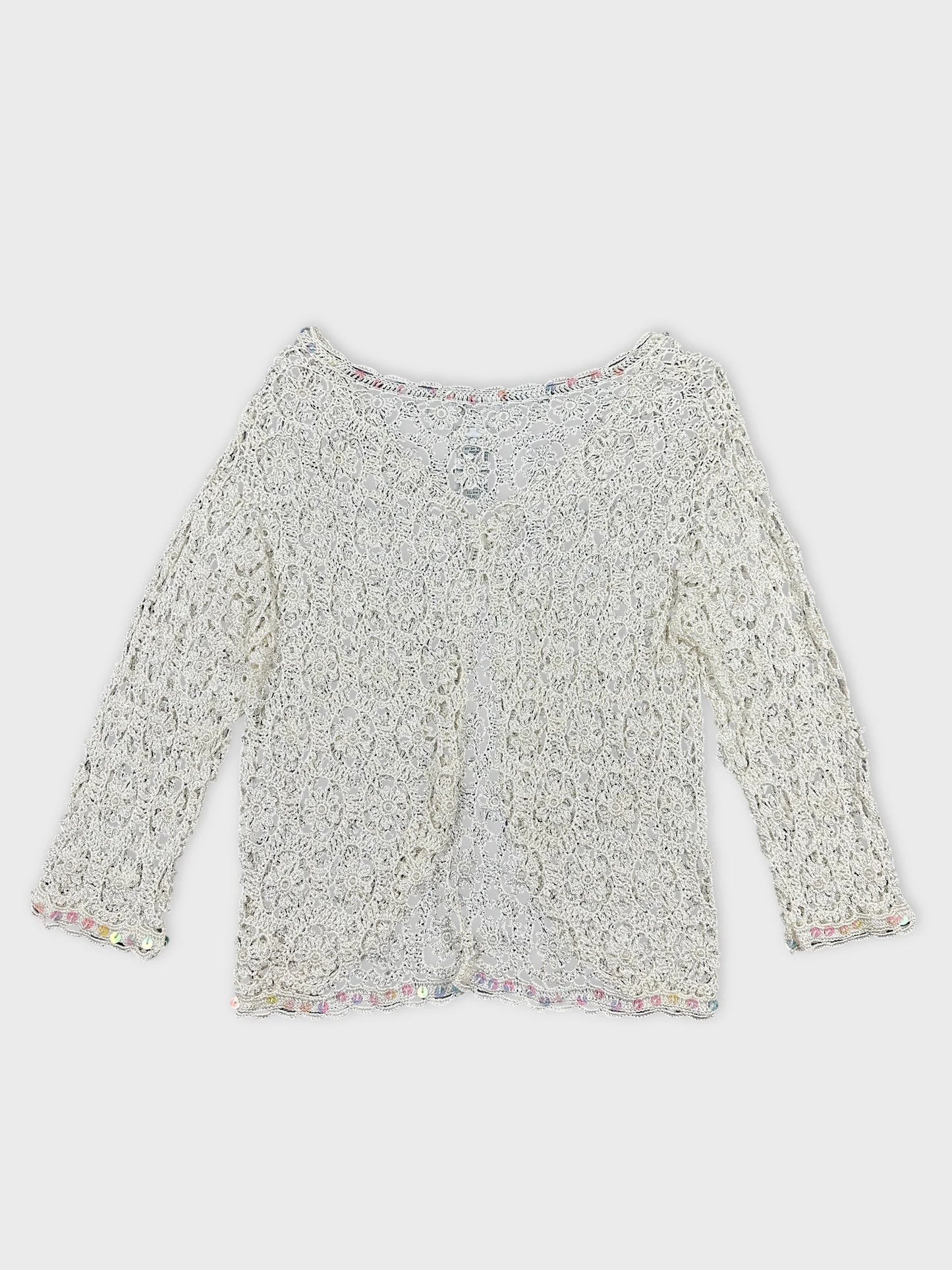 Back view of a white long sleeve top with lace pattern and trim.