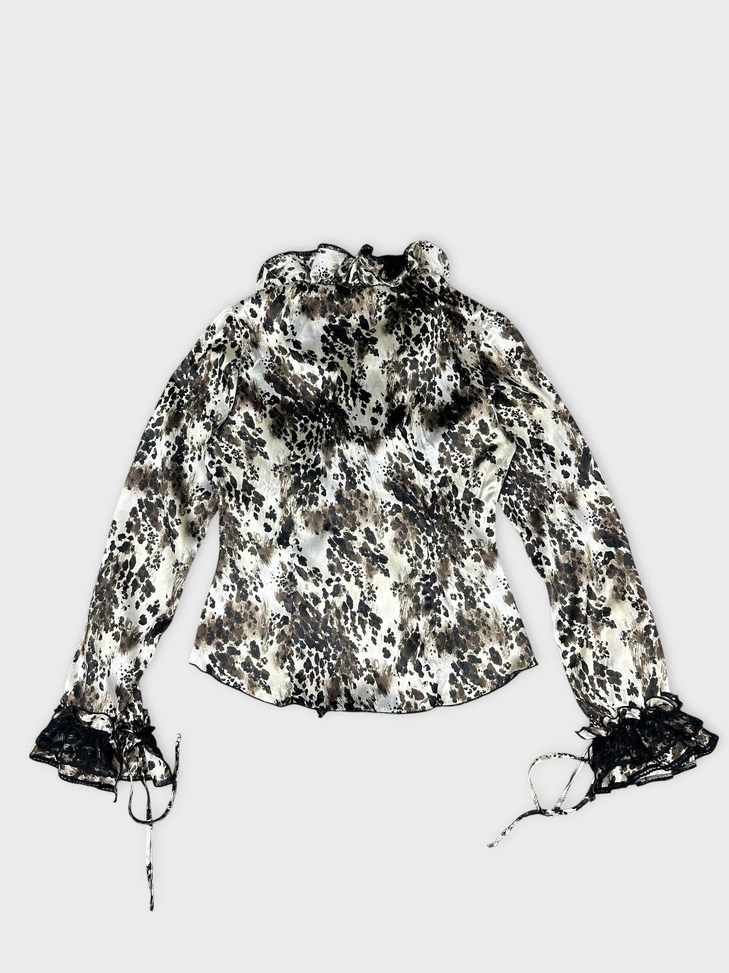 Back view of a long sleeve top in cream with leopard print and lace trim.
