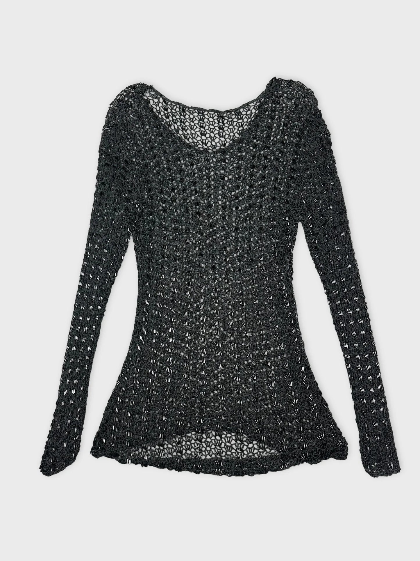 Back view of a black long sleeve top with a knit pattern.