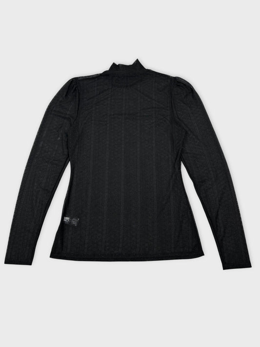 Back view of a black long sleeve top with textured pattern.