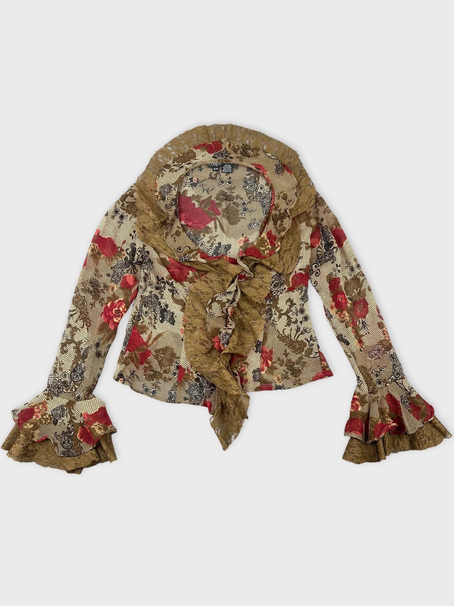 Front view of a long sleeve floral print top in brown with ruffled trim.