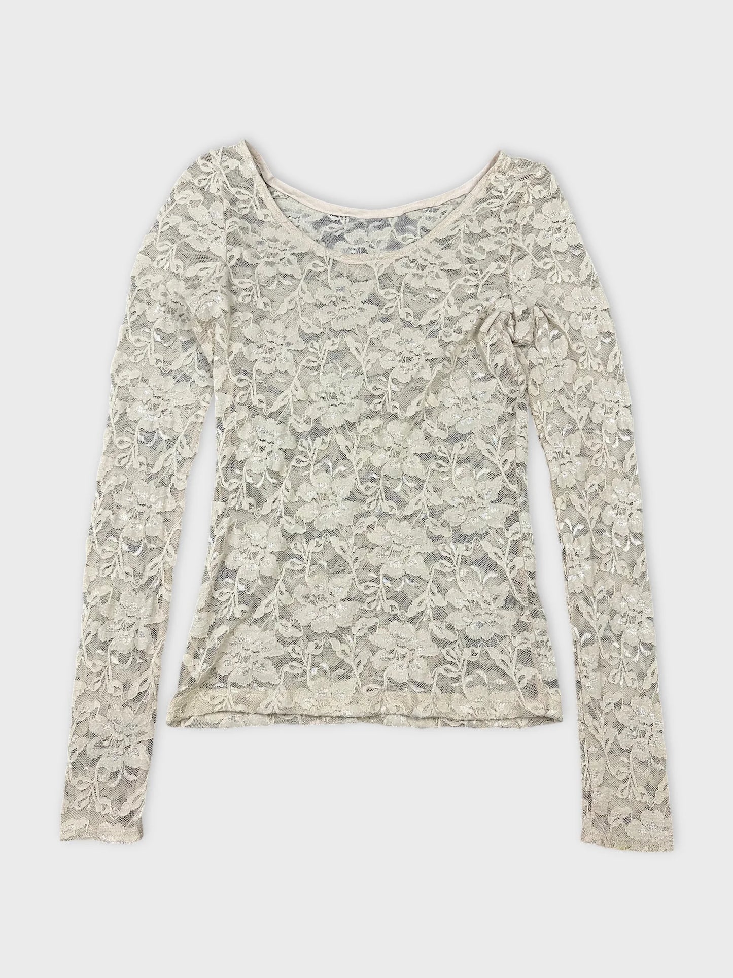 Front view of a long sleeve top in light beige lace pattern.