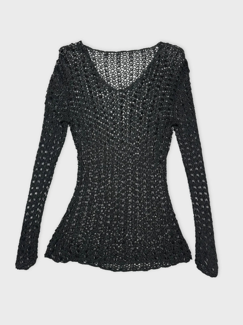 Black long sleeve top with open knit pattern in front view.