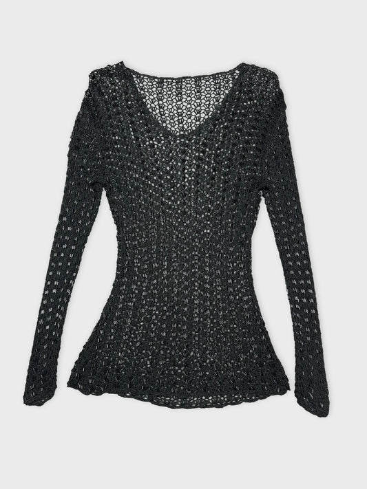 Black long sleeve top with open knit pattern in front view.