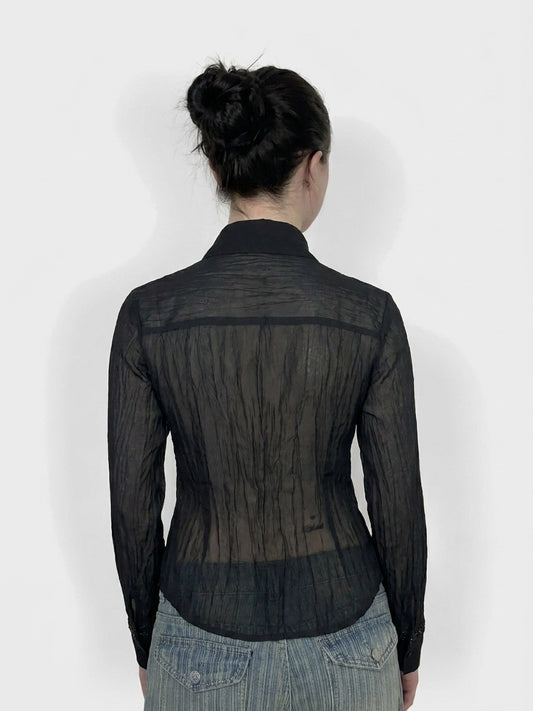 Back view of a black long sleeve top with a sheer textured design.