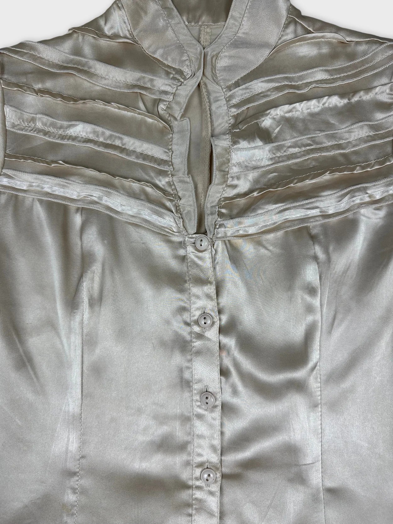 Detail view of a women's short sleeve button up shirt in light silver.