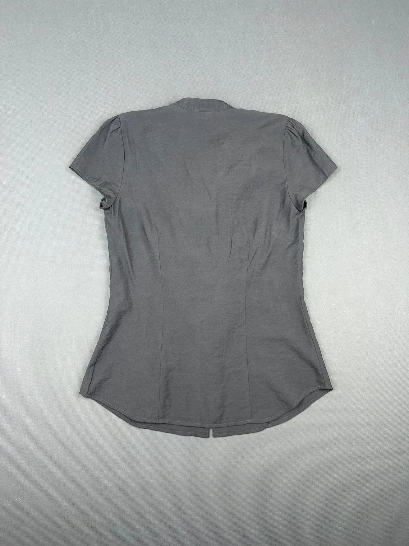 Back view of a gray short sleeve shirt with a curved hem.